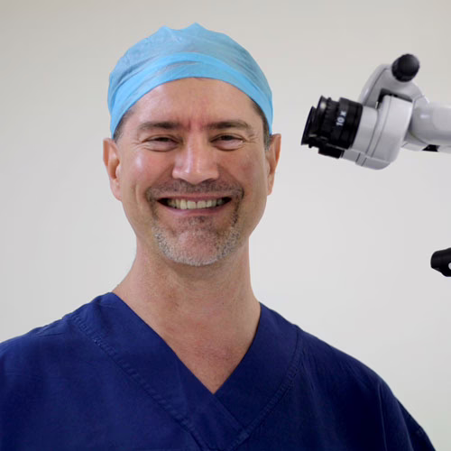 Dr Theron in surgical scrubs and cap