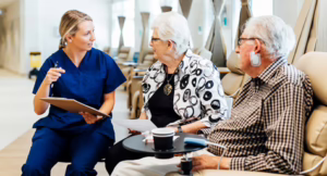 day surgery centre nurse talking with two elderly patients