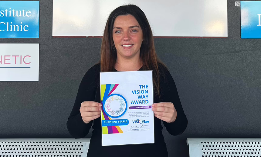 Christine Searle holding her award