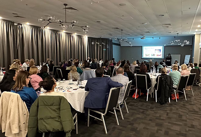 Picture of people groups of people seated in a large hall at the AONA Conference in Melbourne.