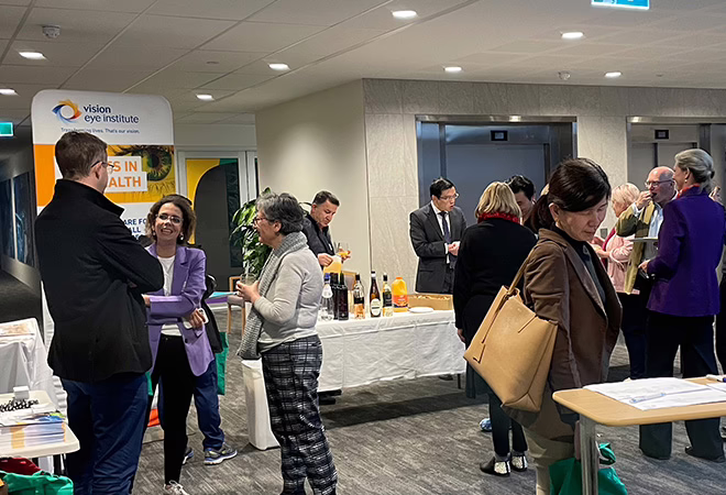 A picture of the Vision Eye Institute banner and table at AONA in Melbourne.