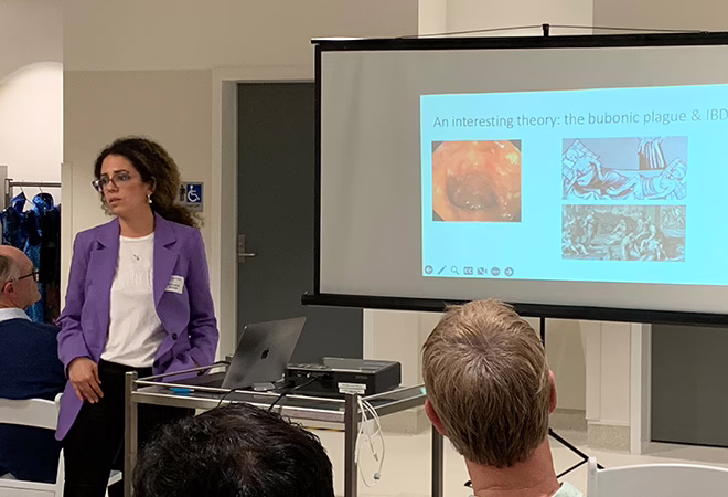 A picture of a clinician in a purple blazer giving a presentation at AONA in Melbourne.