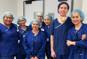 Dr Jack Kane and the ophthalmic nursing team at Boroondara Day Surgery in surgical scrubs, smiling at the camera.