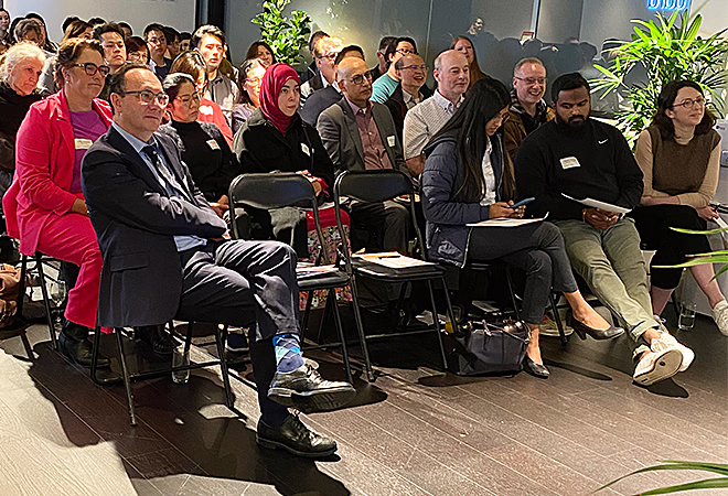 The audience members at the CPD event – taking notes as they listen to a presentation.