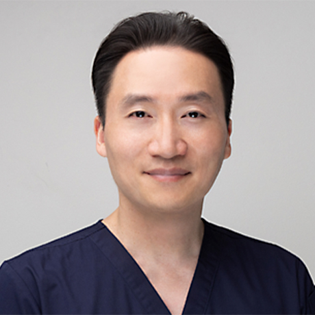 Headshot of Dr Michael Wei in dark blue scrubs against a white background